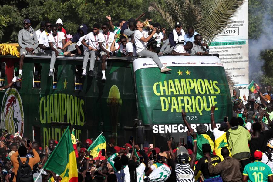 CAF Africa Cup of Nations - Morocco 2025 - Final - Senegal Victory Parade - Dakar, Senegal - Jan 20, 2026 Senegal players and staff celebrate with the trophy on the bus during the victory parade REUTERS/Zohra Bensemra