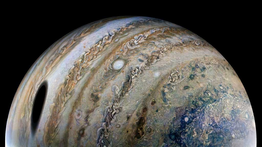 An enhanced-color image, using raw data from the JunoCam instrument aboard NASA’s Juno spacecraft, shows the planet Jupiter, with a shadow of its moon Ganymede on the left, released by NASA on Apr 21, 2022. Photo: Reuters