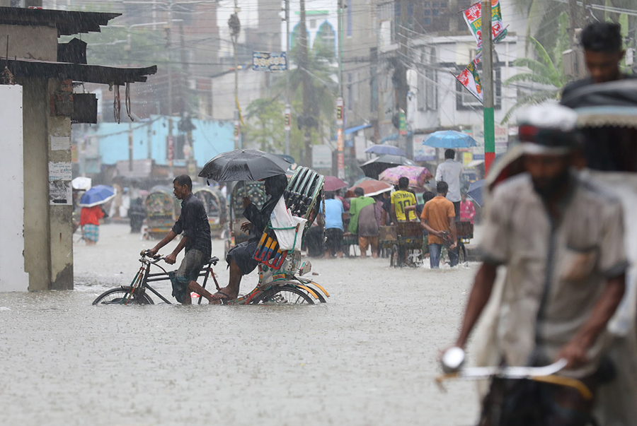 Different areas of the port city have been under knee-deep water due to torrential rains for the last several days, making it difficult for people to move from one place to another — Focus Bangla photo used for representation