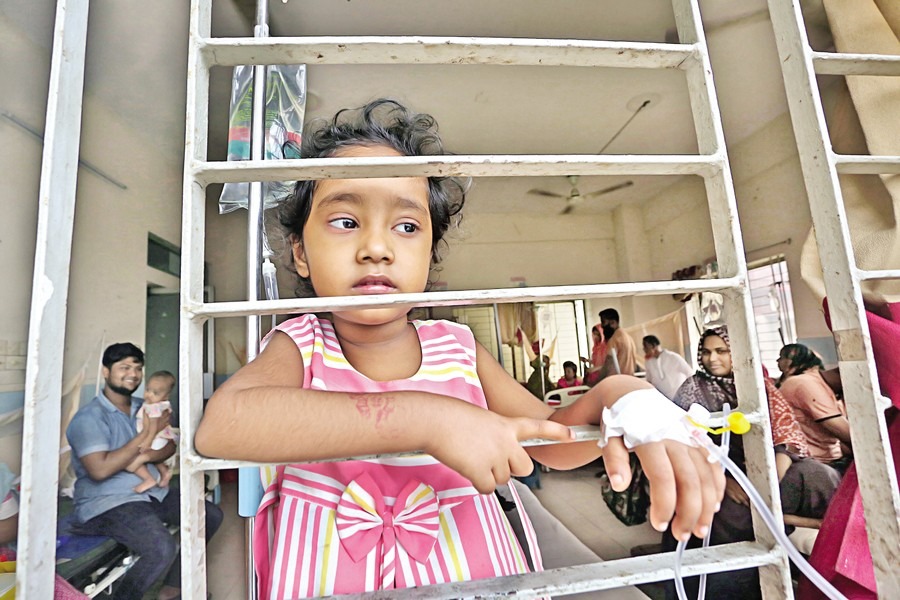 With saline needle attached to her hand, four-year-old Raisa gazes out of the window at Mugda General Hospital in Dhaka on July 13 this year as she now feels better after undergoing treatment for dengue.