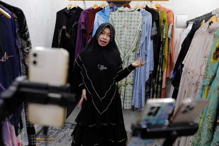 Bening Widayati, 40, selling clothes live on a social media platform inside her stall at the International Trade Centre (ITC) mall in Jakarta on Wednesday –Reuters file photo