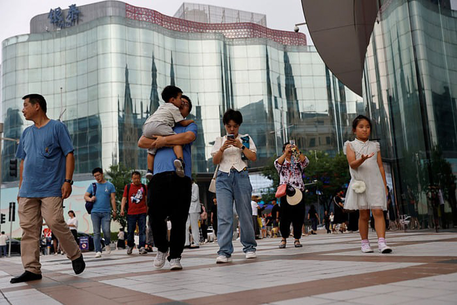 People walk at a shopping area in Beijing, China September 5, 2023.