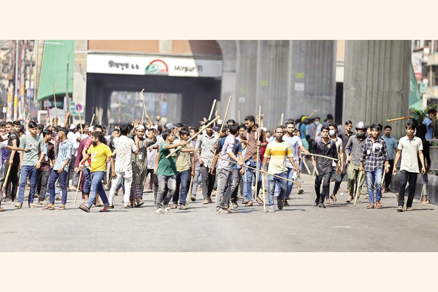 Garment workers block a road at Mirpur-11 in the city on Tuesday following an allegation that workers of a factory there came under attack for staging demonstration. — Focus Bangla