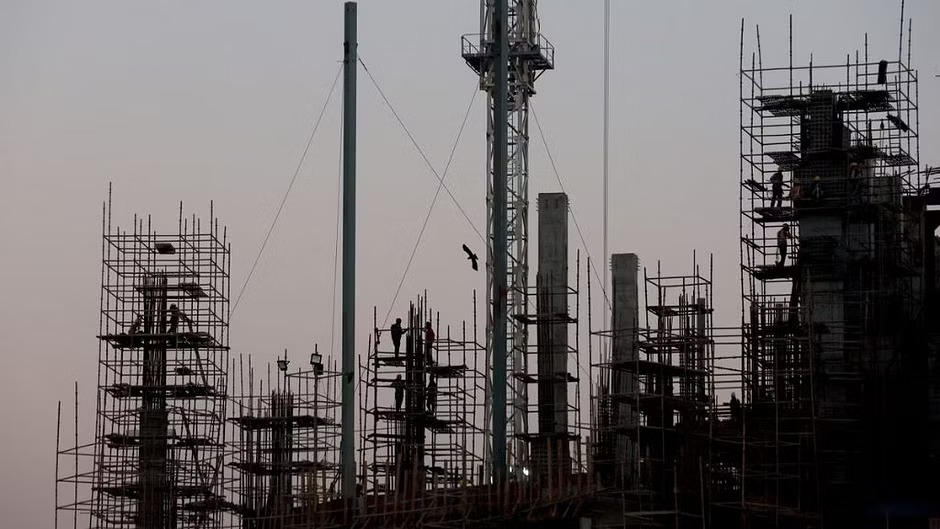 Labourers work at the construction site of a commercial building in New Delhi, India, Dec 13, 2022.