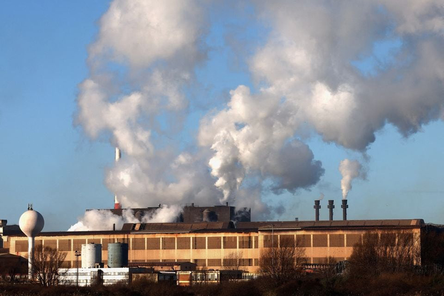 Smoke rises from chimneys at a factory in the port of Dunkirk, France January 19, 2023.