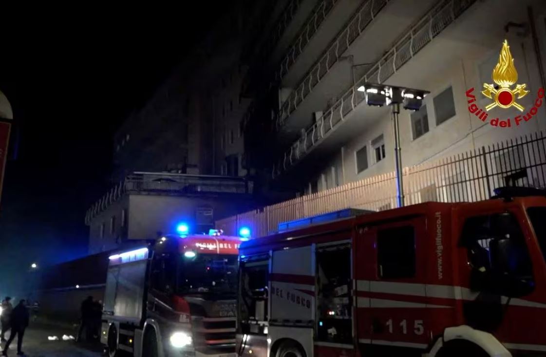 People walk next to fire engines parked at the San Giovanni Evangelista hospital, following a deadly fire, in Tivoli, around 30 km from Rome, Italy December 9, 2023. Vigili del fuoco/Handout via REUTERS