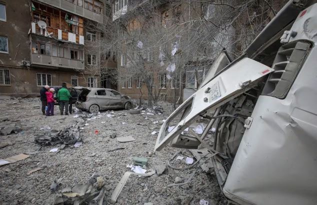 Local residents stand near their apartment building and cars damaged during a Russian missile strike, amid Russia's attack on Ukraine, in Kharkiv, Ukraine December 8, 2023. REUTERS/Vyacheslav Madiyevskyy