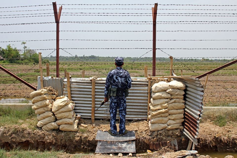 A Myanmar Border Guard Police officer keeps watch near the Taung Pyo Letwe reception camp overlooking the border with Bangladesh, in Rakhine state, Myanmar on May 1, 2018 — Reuters/File