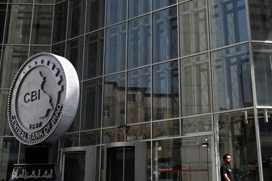 An Iraqi man walks past the headquarters of the Central Bank of Iraq in Baghdad, Iraq August 15, 2023.