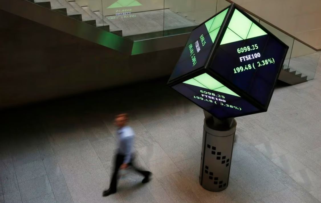 A man walks through the lobby of the London Stock Exchange in London, Britain August 25, 2015. REUTERS/Suzanne Plunkett/ File Photo