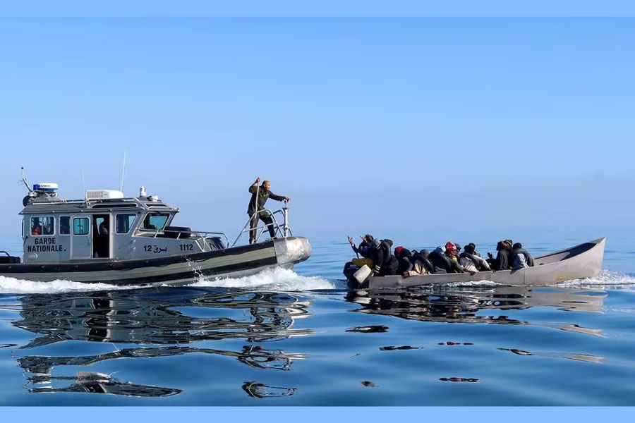 Tunisian coast guards try to stop migrants at sea during their attempt to cross to Italy, off the coast off Sfax, Tunisia April 27, 2023.