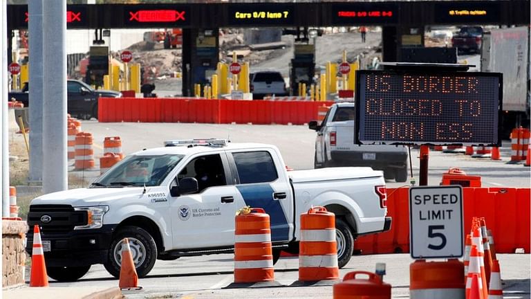 A US Customs and Protection vehicle stands beside a sign reading that the border is closed to non-essential traffic at the Canada-United States border crossing at the Thousand Islands Bridge, to combat the spread of the coronavirus disease (COVID-19) in Lansdowne, Ontario, Canada Sept 28, 2020. REUTERS