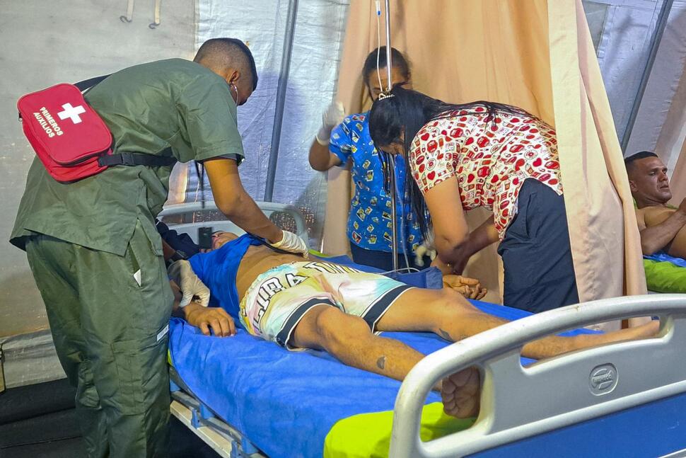 Yorvis Hernandez, a 34-year-old miner, gets medical attention at at tent set up next to a mine after it collapsed in La Paragua, Bolivar state, Venezuela, Wednesday, Feb 21, 2024. (AP Photo/Andrea Calma)