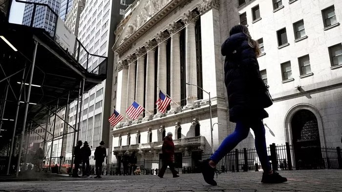 People are seen on Wall Street outside the New York Stock Exchange (NYSE) in New York City, US, Mar 19, 2021.
