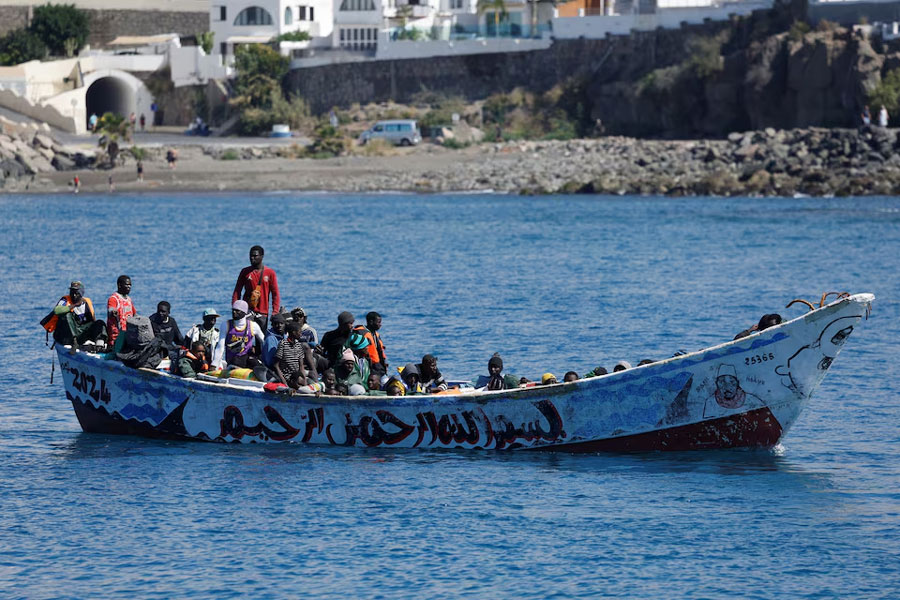 Migrants wait to disembark from a fiber boat in the port of Arguineguin, on the island of Gran Canaria, Spain, March 28, 2024.