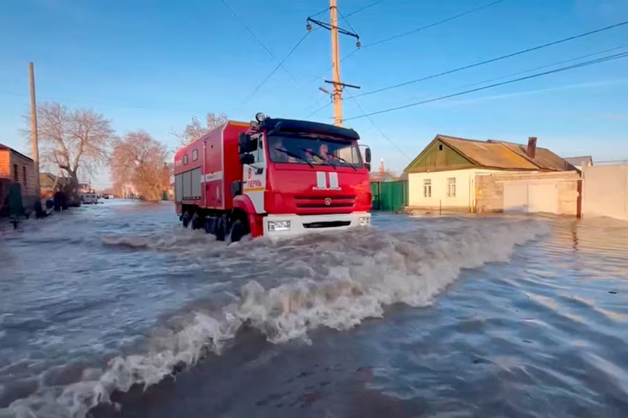 Rescuers drive in a flooded residential area in the city of Orsk, Russia, April 6, 2024, in this still image taken from video.