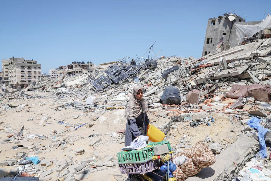 A Palestinian is pictured on the debris in Gaza City, April 13, 2024.