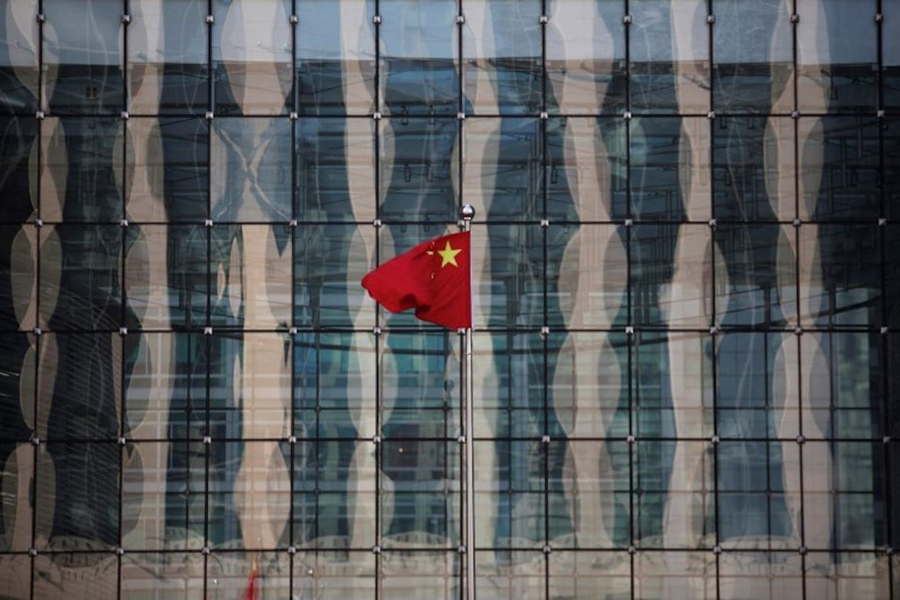 A Chinese national flag flutters at the headquarters of a commercial bank on a financial street near the headquarters of the People's Bank of China, China's central bank, in central Beijing on November 24, 2014 — Reuters/File