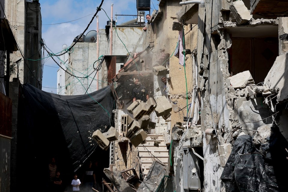 Palestinians look at damages following an Israeli raid at Nur Shams camp, in Tulkarm, in the Israeli-occupied West Bank on April 21, 2024 — Reuters photo