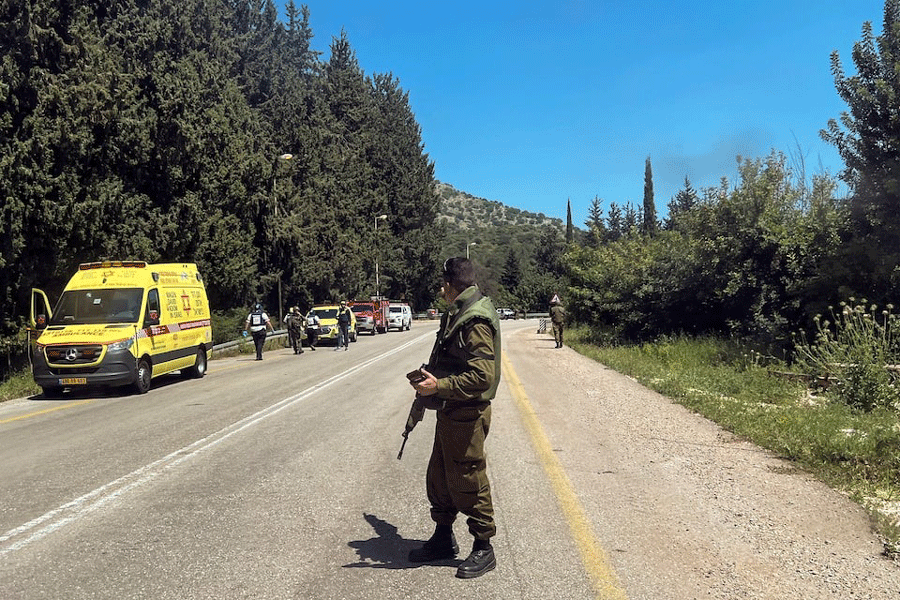 An Israeli soldier looks on at a scene, after it was reported that people were injured, amid ongoing cross-border hostilities between Hezbollah and Israeli forces, near Arab al-Aramashe in northern Israel April 17, 2024.