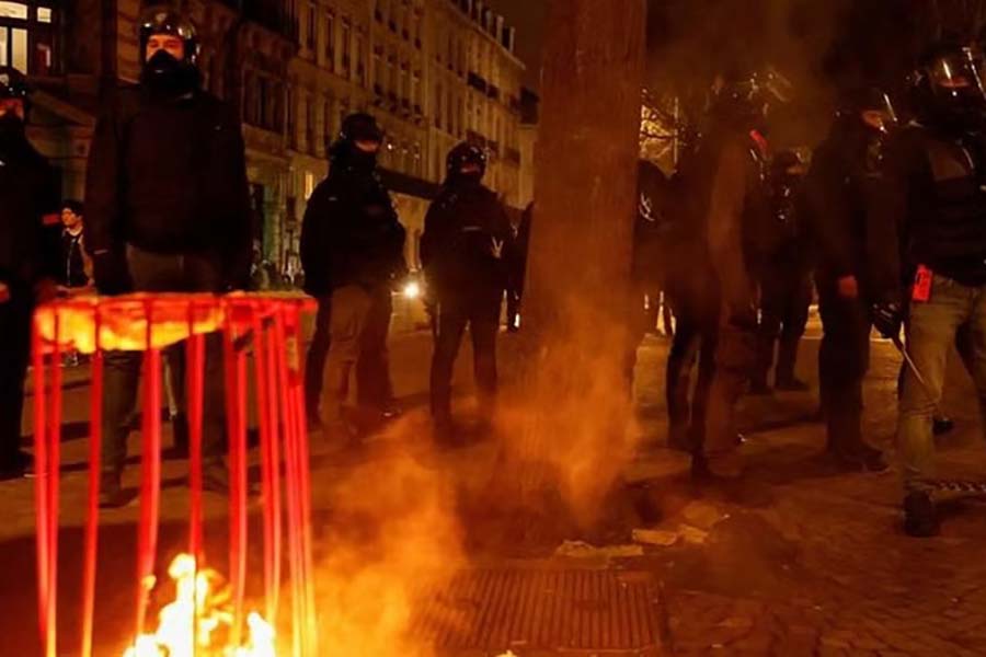 French police stand guard, amid clashes during a demonstration, on the day the National Assembly debates and votes on two motions of no-confidence against the French government, tabled by centrist group Liot and far-right Rassemblement National party, for its use of article 49.3, a special clause in the French Constitution, to push the pensions reform bill through the National Assembly without a vote by lawmakers, in Lille, France, Mar 20, 2023.