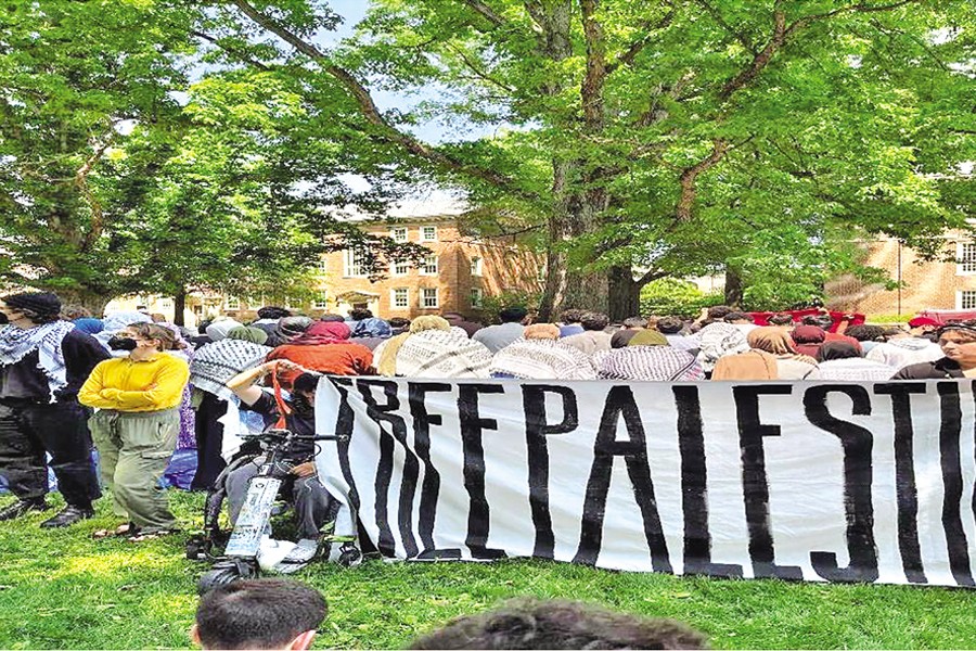 Muslims at the encampment praying Jummah prayer while students guard, April 26