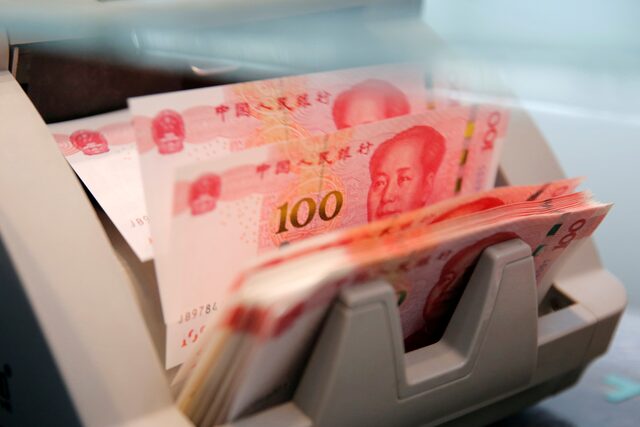 Chinese 100 yuan banknotes are seen in a counting machine at a branch of a commercial bank in Beijing, China, on March 30, 2016 — Reuters/File