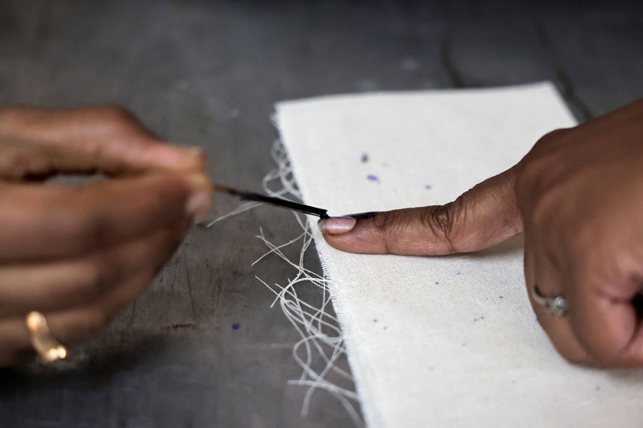 A woman gets her finger ink marked as she prepares to vote at a polling station, during the second phase of the general elections, at Bengaluru, in Karnataka, India on April 26, 2024