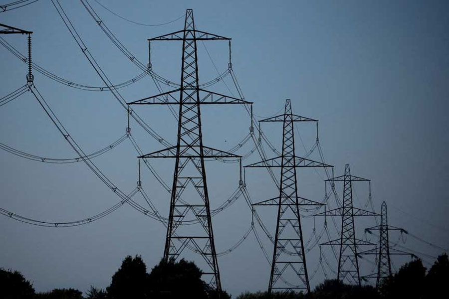 A row of electricity pylons is seen near the Frodsham on shore wind farm in Frodsham, Britain, September 5, 2023.