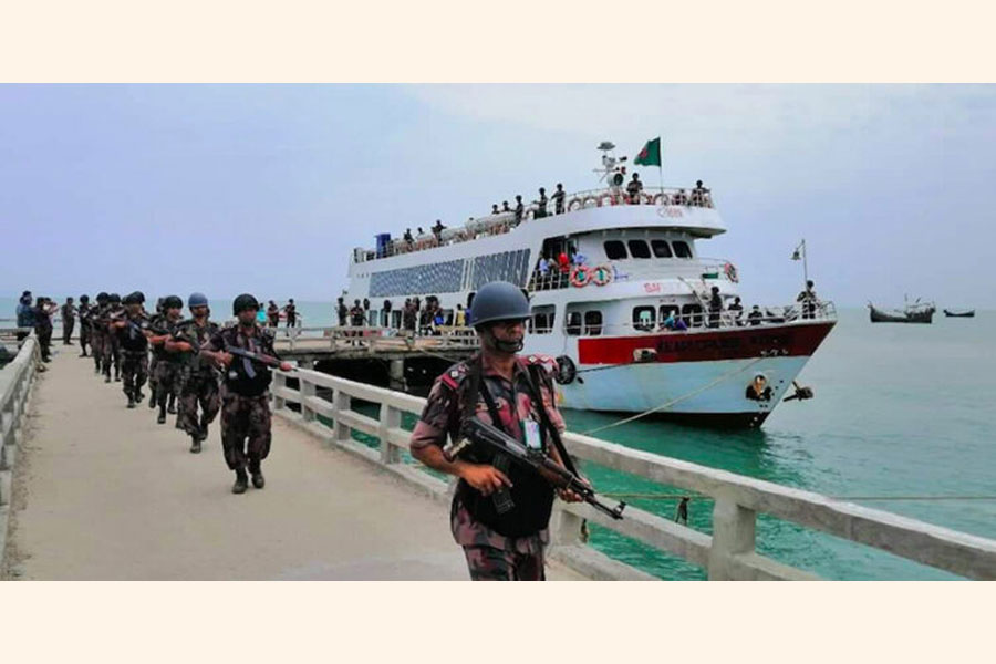 Border Guards Bangladesh (BGB) personnel get off from a civilian vessel to begin their deployment on St Martin's Island on April 7, 2019