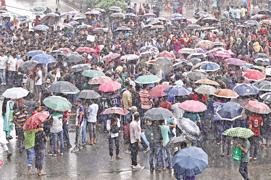 University students in Dhaka blockade the Shahbagh intersection on Thursday, defying heavy rain. They are protesting against the reinstatement of the quota system in government jobs by the High Court. The students lifted their over five-hour blockade later in the evening after announcing new programmes of their campaign