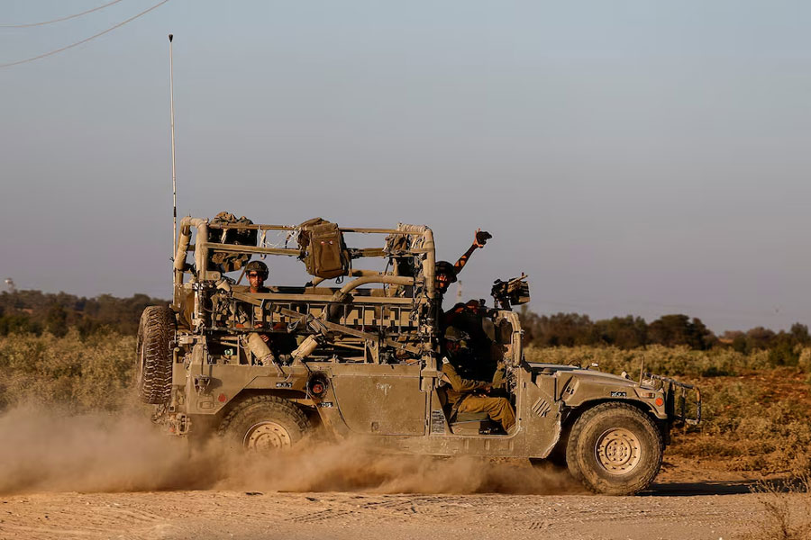 Israeli soldiers travel in a military vehicle, amid the Israel-Hamas conflict, by the Israel-Gaza border, in Israel, July 23, 2024.