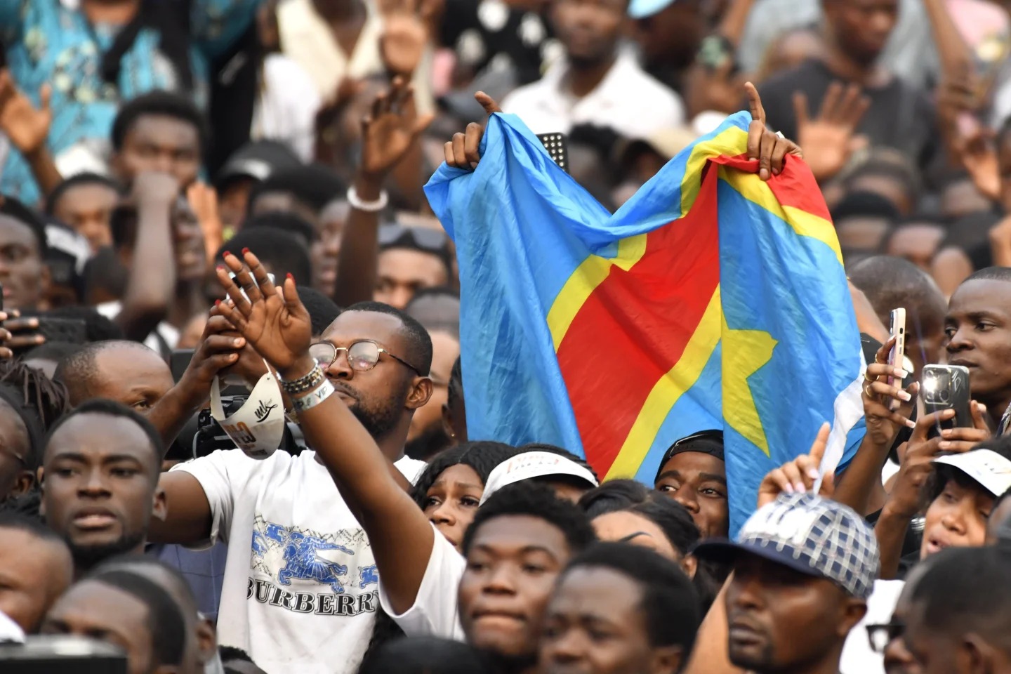 People attend a music concert at the Stade des Martyrs of Kinshasa, Democratic Republic of Congo, Saturday, July 27, 2024. Multiple people were killed and many others were injured during a stampede at the concert, according to authorities. (AP Photo/Samy Ntumba Shambuyi)