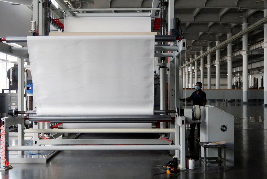 An employee works on the filter cloth production line at Jingjin filter press factory in Dezhou, Shandong province, China August 25, 2022. REUTERS/Siyi Liu