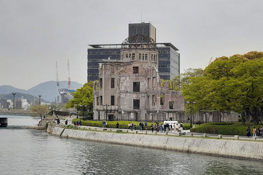 Visitors watching the only survived structure of a building in Hiroshima city destroyed by atomic bomb