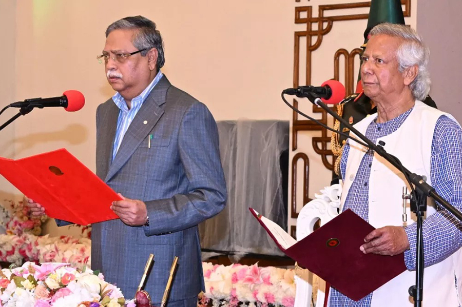 Muhammad Yunus (right) takes the oath of office as the chief adviser of Bangladesh's new interim government during the oath-taking ceremony administered by President Mohammed Shahabuddin in Dhaka on Thursday — PID photo