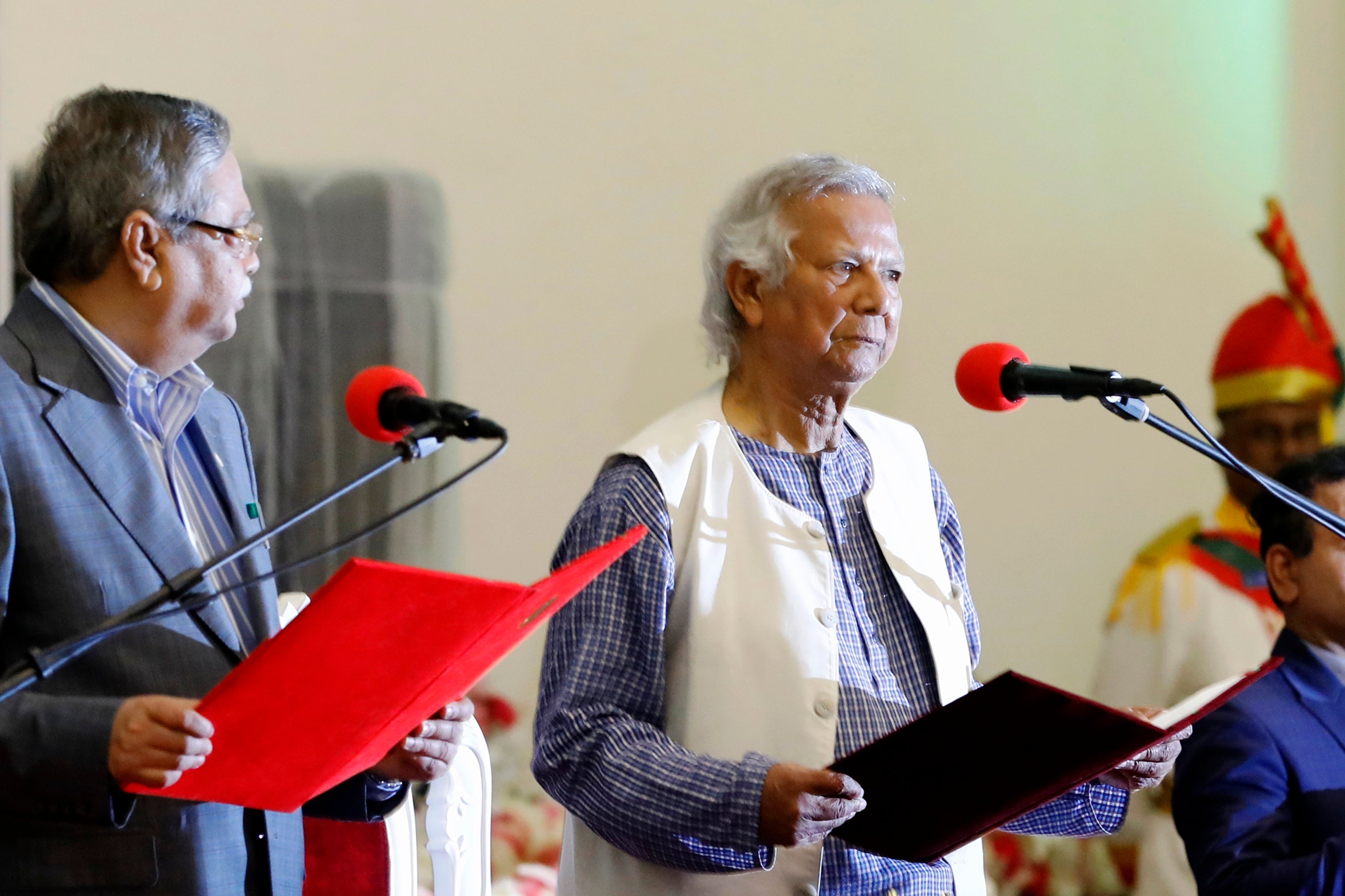 Nobel laureate Muhammad Yunus, right, takes the oath of office as the head of Bangladesh's interim government in Dhaka, Bangladesh, August 8, 2024. AP PHOTO