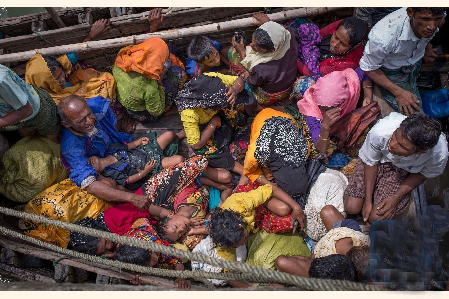 Photo taken on Sept. 12, 2017 shows Rohingya refugees arriving by boat at Shah Parir Dwip on the Bangladesh side of the Naf River after fleeing violence in Myanmar