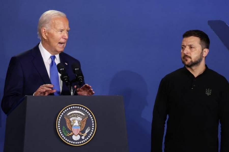 Ukraine’s President Volodymyr Zelenskiy listens to US President Joe Biden speak at a Ukraine Compact meeting, on the sidelines of the NATO’s 75th anniversary summit in Washington, US, July 11, 2024.