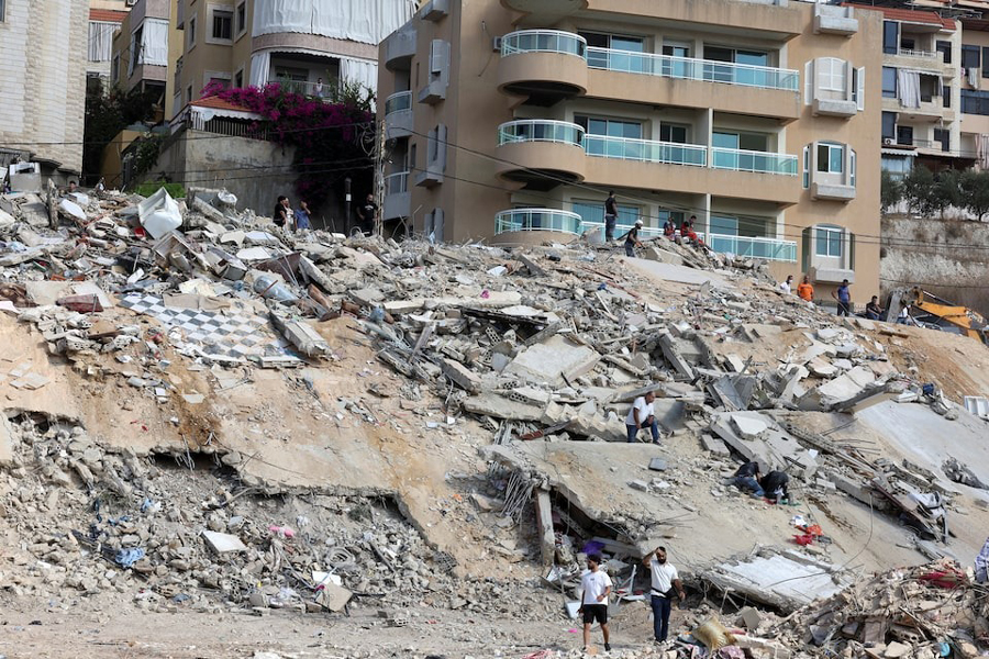 People inspect the damage at the site of Sunday's Israeli attack on the city of Ain Deleb, amid the ongoing hostilities between Hezbollah and Israeli forces, in southern Lebanon September 30, 2024.