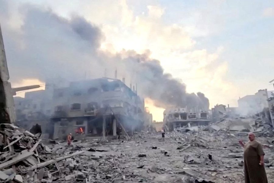 People survey the destruction at Gaza’s Jabalia refugee camp, following Israeli strikes on the enclave, October 14, 2023 in this still image from video obtained by REUTERS/Files