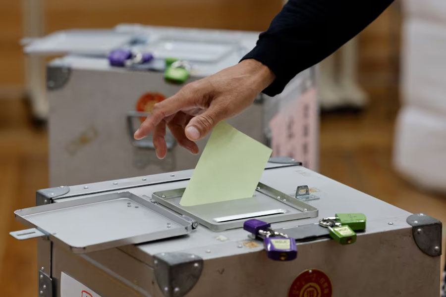 A man casts his ballot during the general election at a polling station in Tokyo, Japan October 27, 2024.