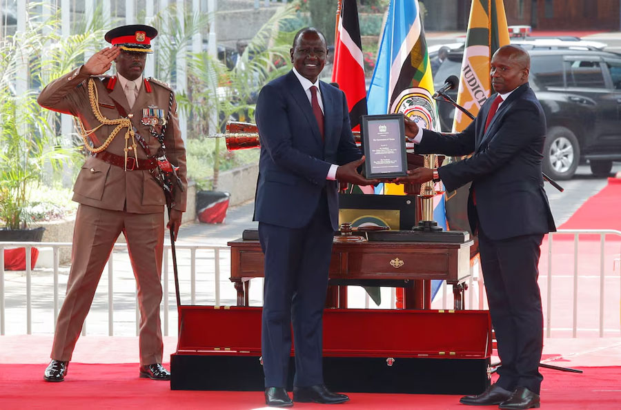 Kenya's President William Ruto hands over the Kenyan constitution to Deputy President Kithure Kindiki after he took the oath of office during his swearing-in ceremony, after his predecessor, Rigathi Gachagua, was impeached and removed from office amid accusations of gross misconduct and undermining President William Ruto, at the Kenyatta International Conference Centre in downtown Nairobi, Kenya November 1, 2024.