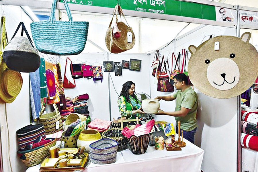 A visitor chooses products at a stall during the National Small and Medium Enterprise (SME) Fair in Dhaka, capital of Bangladesh, on March 6, 2020. Hundreds of small and medium enterprises took part in the fair to promote their products — Xinhua Photo