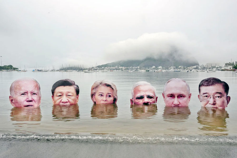 (L to R) Giant portraits of US President Joe Biden, China's President Xi Jinping, President of the European Commission Ursula von der Leyen, India's Prime Minister Narendra Modi, Russia's President Vladimir Putin, and Japan's Prime Minister Shigeru Ishiba are submerged by indigenous people to protest the lack of leadership among the world's richest nations on addressing the climate and biodiversity crisis in Rio de Janeiro, Brazil, on 16 November, 2024, ahead of the G20 Summit. —AFP