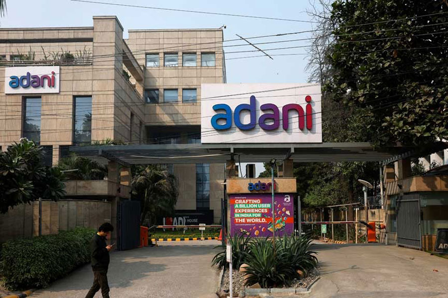 A man walks past a corporate office of Adani Group in Gurugram, India, Nov 22, 2024.