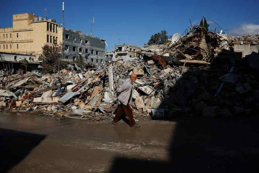 A man walks past rubble of destroyed buildings which was previously a market area, in the southern Lebanese town of Nabatieh, on the second day of the ceasefire between Israel and Hezbollah, Lebanon November 28, 2024.