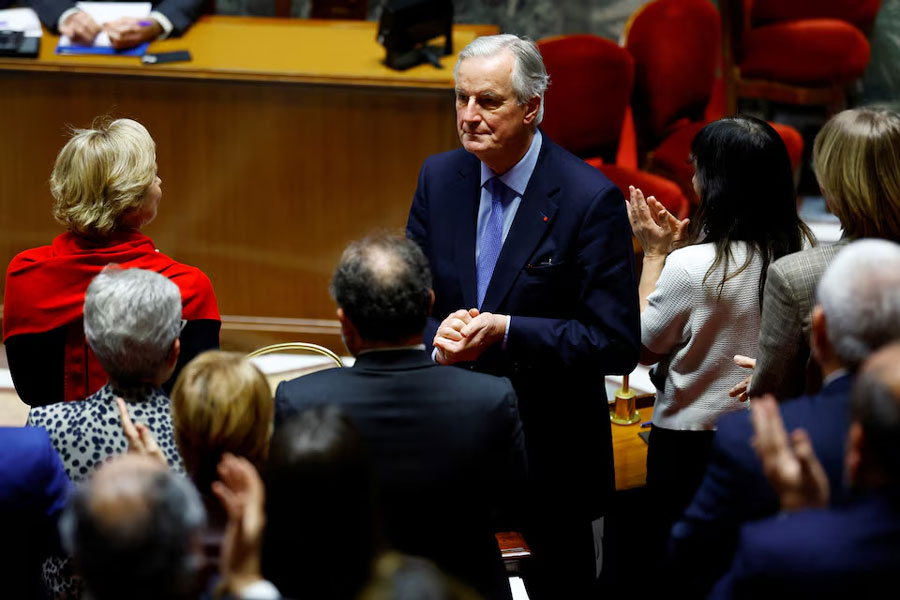 French Prime Minister Michel Barnier is applauded by members of the French government after he delivered a speech during a debate on two motions of no-confidence against the French government, tabled by the alliance of left-wing parties the "Nouveau Front Populaire" (New Popular Front - NFP) and the far-right Rassemblement National party, after the use by French government of the article 49.3, a special clause in the French Constitution, to push the budget bill through the National Assembly without a vote by lawmakers, at the National Assembly in Paris, France, December 4, 2024.