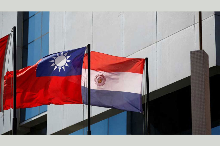 The national flags of Paraguay and Taiwan are pictured outside the building housing Taiwan’s embassy, in Asuncion, Paraguay April 19, 2023.