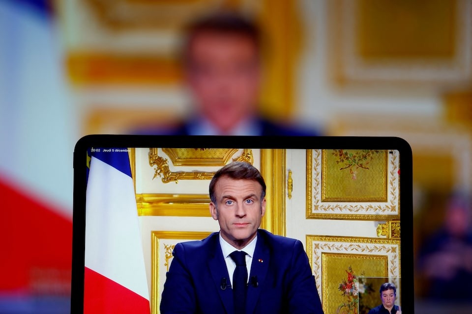 French President Emmanuel Macron appears on screen as he makes a television address to the nation after Prime Minister Michel Barnier's government was toppled in a no confidence vote in parliament, in Paris, France on December 5, 2024 — Reuters photo